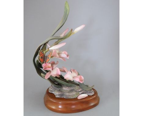 A Royal Worcester Ornamental Studio Orchid, 1983, Limited Edition of 150, number 49. With wooden stand. Factory mark to base.