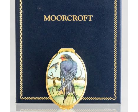A Moorcroft enamel miniature oval lidded trinket box, decorated with swallows, length 5.5cm, in a fitted presentation box Con