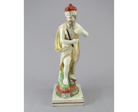 An early nineteenth century Staffordshire pearlware figure of Neptune on a square base, c.1810-20. He stands on the head of a