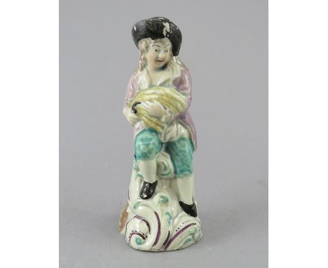 An early nineteenth century pearlware figure, c.1820. It depicts a gleaning man with his sickle and stoop, decorated in colou