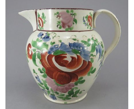 An early nineteenth century pearlware jug, c.1820. It is boldly painted in enamels with flowers and leaves. 17 cm tall. (1)Co