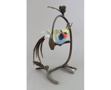 An Albany Fine China Co. ceramic bird study incorporating metal. Modelled as an exotic bird. 20 cm tall. (1)Condition: In goo