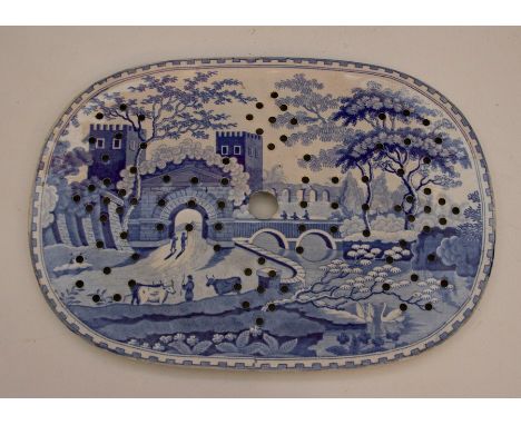 An early nineteenth century Castle pattern large blue and white transfer printed drainer, c.1825. It is well printed with the