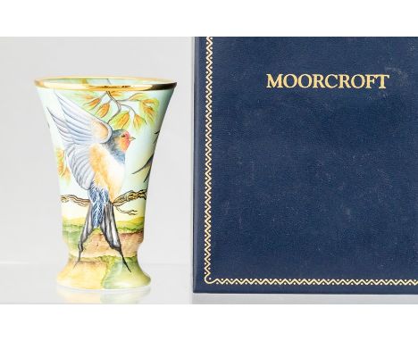 A Moorcroft enamel swallows vase, height 8cm, in a fitted presentation caseCondition: good overall