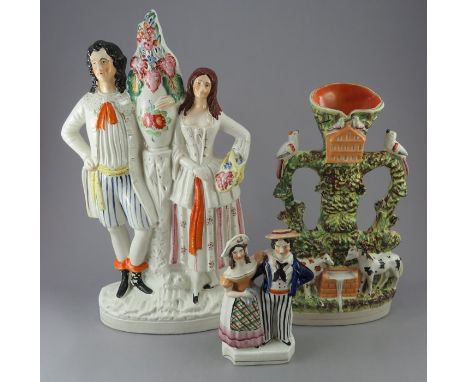 A group of nineteenth century Staffordshire figures, c.1860-70. To include a large figure depicting a couple standing next a 
