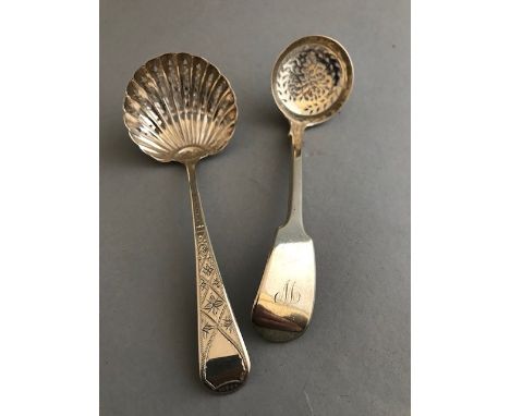 A William IV silver casting ladle, fiddle pattern, London 1837, and a George III sifting ladle, old English pattern with brig