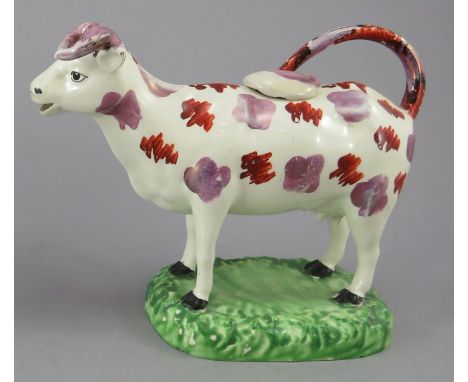 An early nineteenth century creamware Swansea cow creamer, c.1820. It is decorated with red enamel and pink lustre decoration