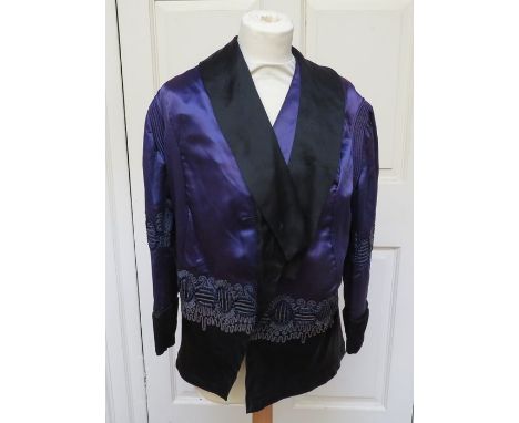 An Italian design garment, a purple satin jacket, 1890-1900, loose fitting, the back is heavily embossed in a striking plumag