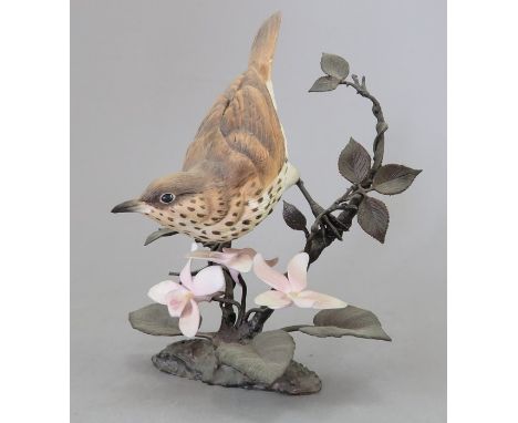 A Royal Worcester ceramic bird study incorporating metal. Modelled as a Thrush. Factory mark to metal base. 16 cm tall. (1)Co