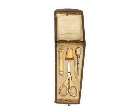 A mid 19th Century French sewing etui of oval section and tapering form, the ebony case inlaid with mother of pearl flowers, 