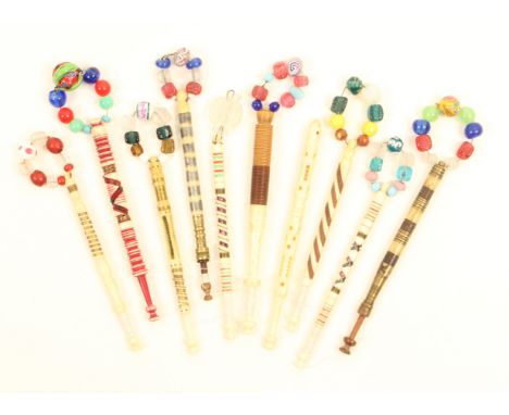 Ten good 19th Century lace bobbins comprising eight bone examples including a church window with miniature bobbin, the others