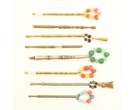 Eight 19th Century metal lace bobbins comprising a brass and steel church window with miniature bone bobbin, four brass, a wh