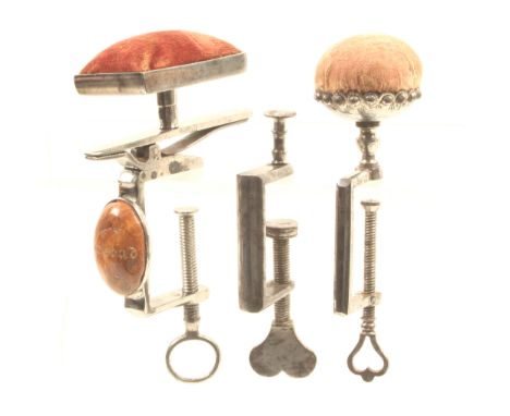 Three 19th Century steel sewing clamps comprising a rectangular frame example mounted with an oval polished stone engraved ‘K