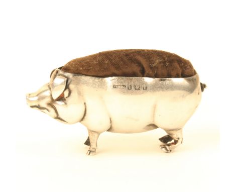 A large silver pin cushion  in the form of a standing pig, Birmingham, by Sanders and Hollings, 8cm.