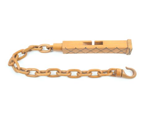 A 19th Century boxwood ‘chained’ knitting stick of square section, one side inlaid with a black trellis design, the 28cm chai