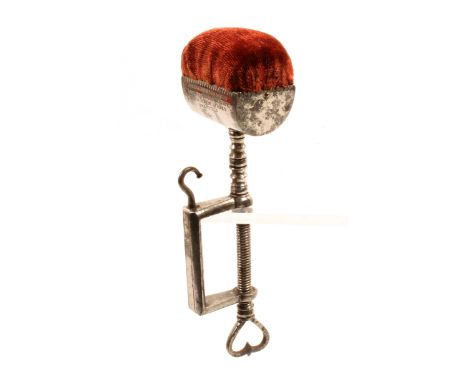A scarce steel sewing clamp by Joseph Rodgers And Sons the rectangular frame with hook below a turned pillar below a trough f