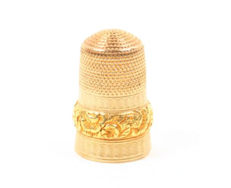 A 19th Century gold thimble the engine turned frieze divided by a raised band of flowers.