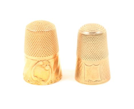 Two gold thimbles, one with ‘C’ scroll cartouche within spiral border, the other with engine turned frieze and vacant cartouc