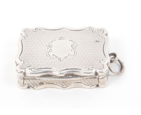 A Victorian silver vinaigrette of shaped rectangular form, engine turned decoration with vacant cartouche to lid, internal gi