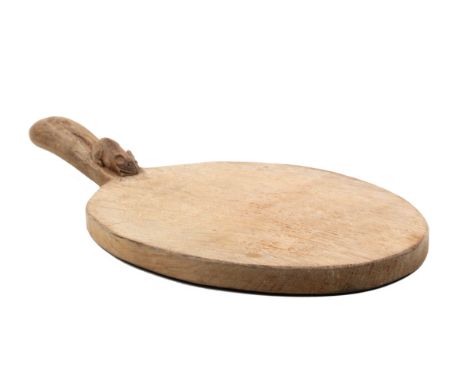 A ‘Mouseman’ Thompson oval oak bread board the handle carved with a mouse, 37cm.