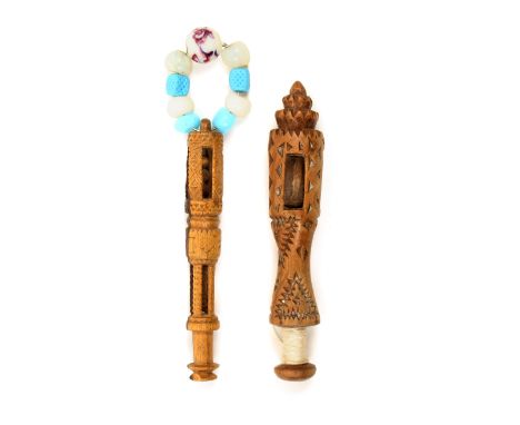 Two good 19th Century wooden knife carved lace bobbins comprising a well carved example with two church windows, one with thr