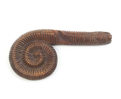 An unusual early 19th Century wooden knitting stick carved in the form of an ammonite, split to end, 10cm.