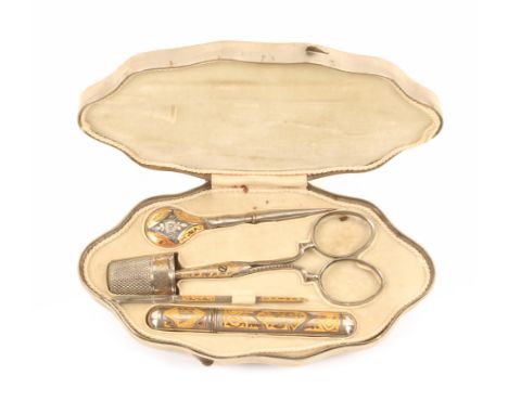 An early 20th Century steel and gilded etui of shaped oval outline the lid with a panel of buildings within scroll borders, t