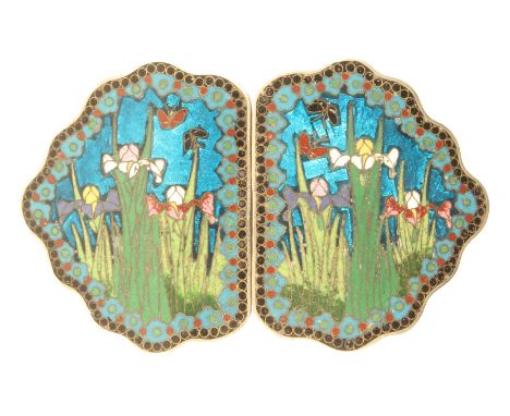 A late 19th Century lady’s cloissone enamel buckle, each half of shaped outline brightly enamelled with lilies and butterflie