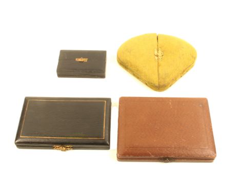 Four late 19th Century small format sewing companions comprising a green plush triangular form example, and three leather and