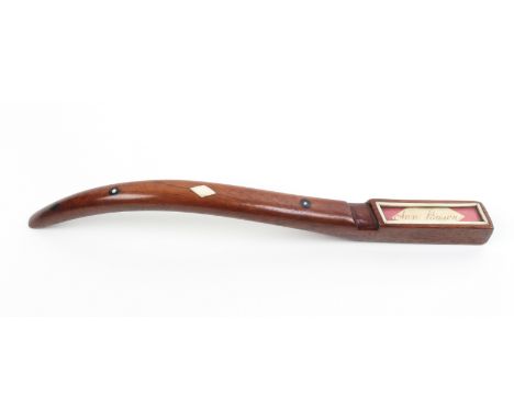 An elegant 19th Century mahogany knitting stick of square section, curved and tapering, inlaid in bone and ebony with geometr
