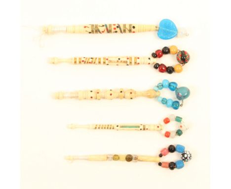 Five good 19th Century bone lace bobbins comprising a church window with miniature green stained bobbin, another, an example 