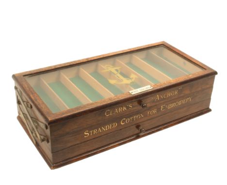 A “Clark’s Anchor” embroidery oak counter display cabinet of rectangular form, three cantilever sections, hinged glazed lid w