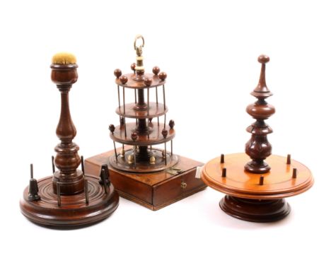 Three 19th Century wooden reel stands comprising a Georgian fruitwood example the rectangular base with drawer, below three c