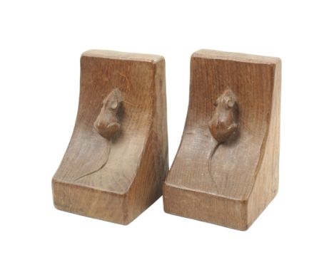 A pair of ‘Mouseman’ Thompson oak bookends, each with swept mouse carved end with adzed sides, 15.5cm high. (2)