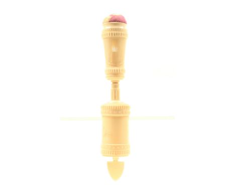 An unusual 19th Century turned, carved and pierced bone French sewing clamp, cylinder form base to a reeded stem supporting a