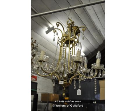 A gilt metal six light chandelier hung with prism drops, approx 65cm.