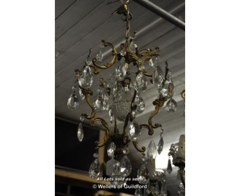 A small gilt brass ceiling light hung with prism drops, approx 40cm.