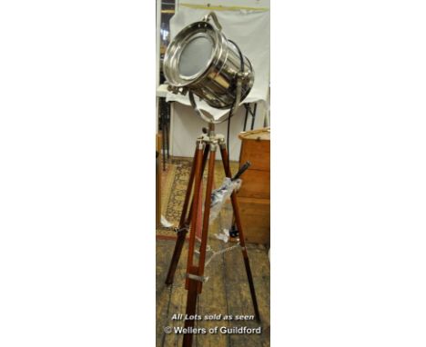 A vintage style chromed projector with tripod.