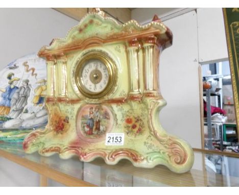 An Edwardian pottery Palladian style mantel clock.