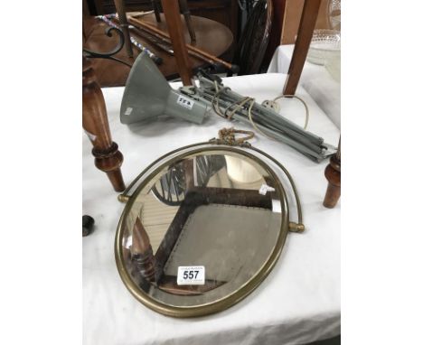 A vintage shelf supporting angle poise lamp and a brass frame mirror