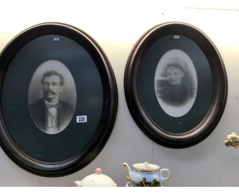 2 oval framed and glazed black and white portrait prints