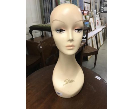 A vintage 'Sleek' shop display mannequin head.