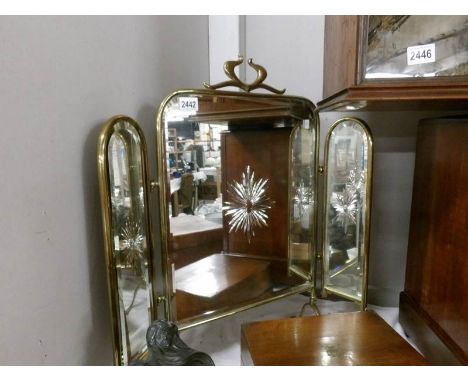 A triple brass firescreen with star cut mirrored glass.