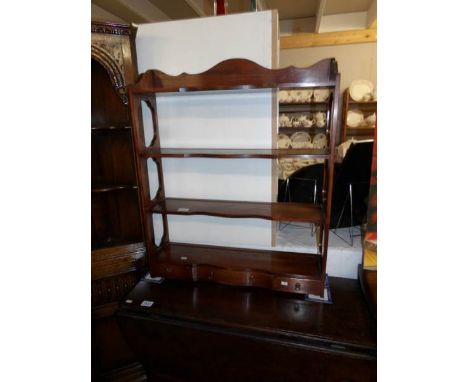 A medium oak book shelf/plate rack with 3 drawers.