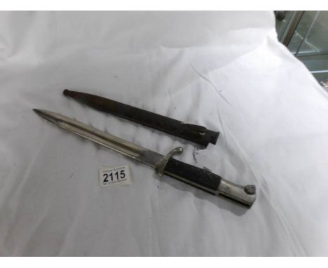 An unidentified knife bayonet with scabbard (no marks observed but similar to the German fire service bayonet).