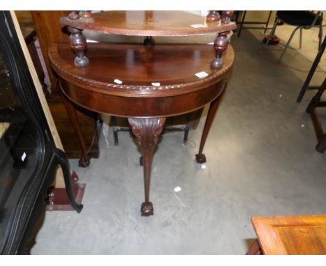 A Victorian mahogany fold over D end card table with ball and claw feet and pull out leg.