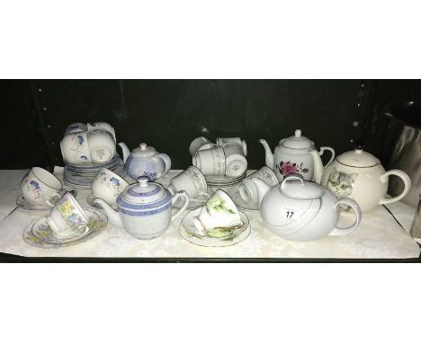 A shelf of porcelain cups, saucers and teapots