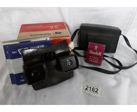 A Kodak camera, a Viewmaster 3D viewer and a boxed Dunhill lighter.