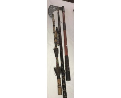 An ornamental medieval style pole axe, tribal spear and one other item.