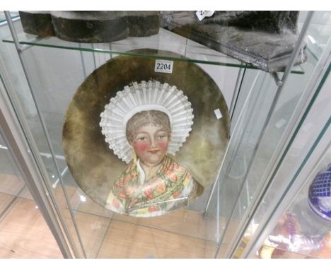 A Victorian charger featuring a portrait of a woman signed D. J. Macdonnell '81.